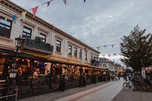 a street with buildings and people walking on the street at Neptuni Bed and Kitchen in Varberg