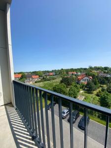 a balcony with a view of a parking lot at Apartament Wrocław-Lotnisko in Wrocław