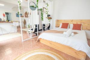a bedroom with two beds and a living room at The Village House in Machico