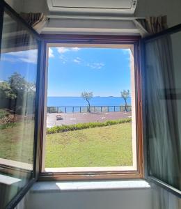 a window in a room with a view of the ocean at Cala Dei Mori in Livorno