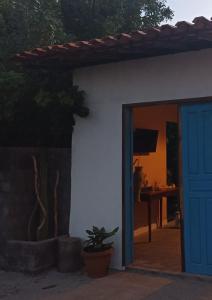 a blue door of a house with a plant at Amorada in Santo Amaro