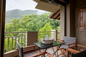a balcony with a table and chairs and a view at Kera valley house in Krásion