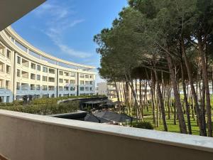 a large building with trees in front of it at EME APARTMENTS - Kompleksi Lura 2 Gjiri i Lalzit in Draç