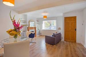 a living room with a table and a dining room at Relax with the whole family at the cosy cottage - Business rates in Marlborough