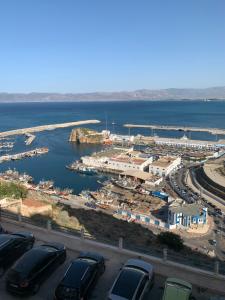 a parking lot with cars parked next to a harbor at Al-marsa2 in Al Hoceïma