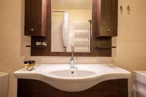 a bathroom with a white sink and a mirror at Kera valley house in Krásion