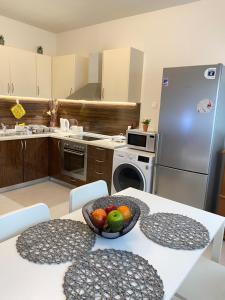 a kitchen with a table with a bowl of fruit on it at Magio House in Ixia