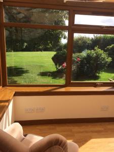 a window in a living room with a view of a yard at Lower Thura House in Wick