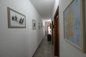 a hallway with pictures on the walls and a hallway with at B&B Su Neulagi in Triei