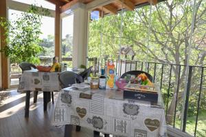 a table and chairs on a screened in porch with food on it at B&B Su Neulagi in Triei