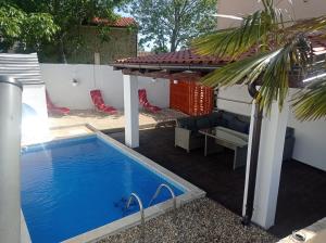 a small swimming pool next to a house with a building at Holiday Home Mumy in Gostinjac