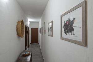 a hallway with pictures of horses on the wall at B&B Su Neulagi in Triei