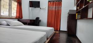 Postel nebo postele na pokoji v ubytování CHARAKAMA Guest Bungalow - GAMPAHA