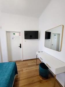 a bedroom with a dressing table and a mirror at Apartments Miljas 2 in Dubrovnik