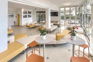 ミザーノ・アドリアーティコにあるSavoia Hotelのテーブルと椅子が備わる病院のロビー
