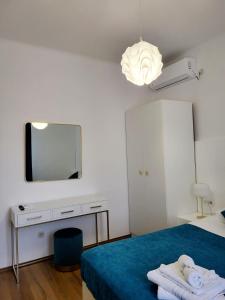 a bedroom with a bed with a mirror and a tv at Apartments Miljas 2 in Dubrovnik