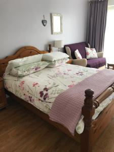 a bedroom with a bed and a couch at Lilac Villa Guest House in Weymouth