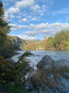 a view of a river with rocks and trees at Emplacement tente, caravane 120 m2, Camping Beaussement in Chauzon