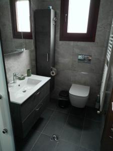 a bathroom with a sink and a toilet at Votsi Seaview in Alonnisos