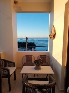 a table and chairs with a view of the ocean at Votsi Seaview in Alonnisos