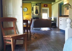 a kitchen and dining room with a table and chairs at Fakânsjehûs Sfeervol met fijne tuin in Irnsum
