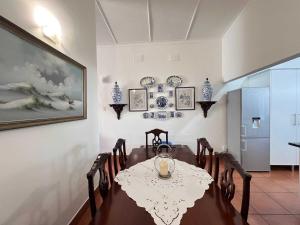 a dining room with a table and chairs at Palm House Accomodation in White River