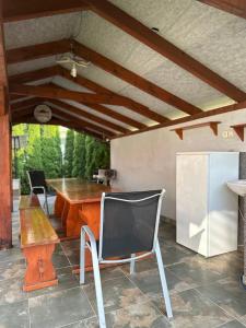 a kitchen with a table and a chair and a refrigerator at Chata Zemplin in Kaluža