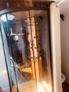 a glass cabinet with a bunch of objects in it at Atypique chambre sur péniche in Strasbourg