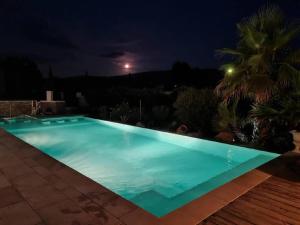 a swimming pool at night in a villa at Tiny House Roulotte in Cuges-les-Pins