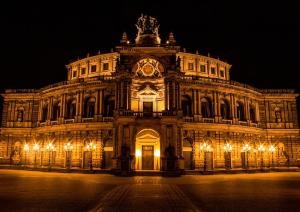 a large building with lights in front of it at night at Apartment-Haus Landeskrone in Dresden