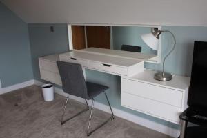 a white desk with a chair and a lamp at Boutique double room with country village views in Wilby