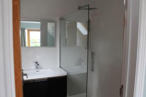 a white bathroom with a sink and a mirror at Boutique double room with country village views in Wilby