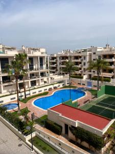 Vista arial de um grande complexo de apartamentos com piscina em PLAYA ALMENARA ATICO DUPLEX VISTAS AL MAR Y MONTAÑA WIFI,PISCINA a em Almenara