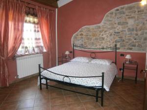 En eller flere senge i et værelse på Agriturismo il Tiglio