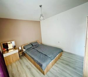 a bedroom with a bed and a television in it at Midtown Apartment in Kŭrdzhali