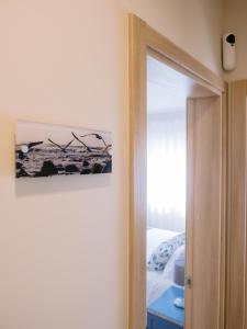 una puerta a un dormitorio con una foto en la pared en Pontes Guest House, en Arcozelo