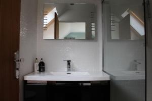 a bathroom with a sink and a mirror at Boutique double room with country village views in Wilby +17 photos