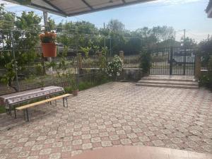 a patio with a bench and a fence at Casa G in Douăzeci şi Trei August