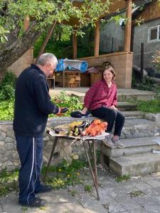 a man giving a woman a table of food at BBQ House in Dilijan