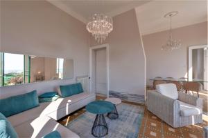 a living room with a couch and a table at [- Poetic Seafront Penthouse Versilia -] in Massa