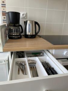 a drawer in a kitchen with a coffee pot and utensils at Spacieux appartement à Blois avec Wifi gratuit in Blois
