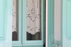 a window with a curtain with birds on it at Galatea House First floor with terraces in Káto Klísma