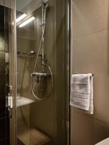 a shower with a glass door with a towel at Imperial apartments in Split +33 photos
