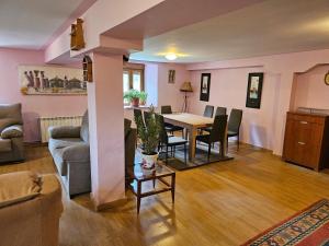 a living room with a table and chairs at El txoko de onso in Santibáñez de la Peña