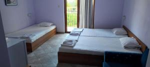 two beds in a small room with a window at Hotel 415 in Sunny Beach