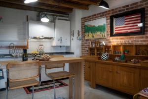 a kitchen with an american flag on the wall at Alilandia - Casa Vacanza in Valdobbiadene