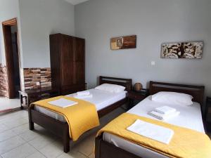 a room with two beds in a room at Galini Apartments Sikinos Travel in Sikinos