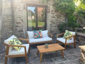a patio with three chairs and a table at Le Saint Michel in Otterswiller