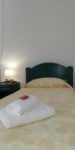 a white towel sitting on top of a bed at 5bedroom villa in perissa beach in Perissa