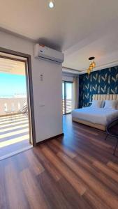 a bedroom with a bed and a sliding glass door at sea view villa with garden in Agadir